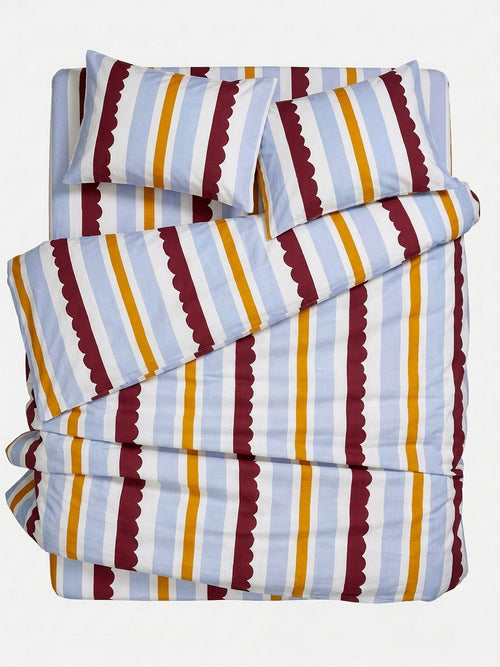 Striped bedding set including a duvet cover and two pillowcases, featuring vertical stripes in light blue, white, mustard yellow, and burgundy with scalloped edges, shown on a plain white background.