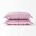 Two pink pillowcases stacked on a white background, featuring a striped pattern with scalloped edges.